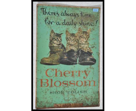 A vintage early 20th century Industrial advertising sign for Cherry Blossom Shoe Polish depicting three kittens sat in boots 