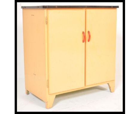 A vintage retro mid 20th Century 1950's / 1960's kitchen cabinet having a white enamelled counter top and peach twin doors wi