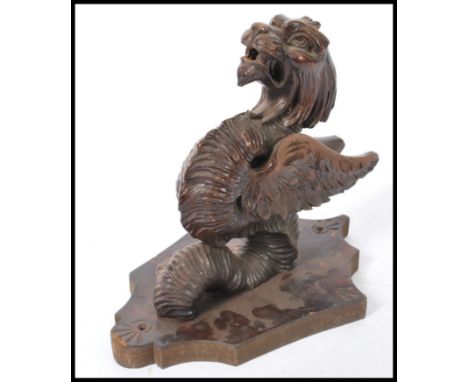A 20th Century carved wood architectural wall mount in the form of a mythical creature, dragon / griffin.