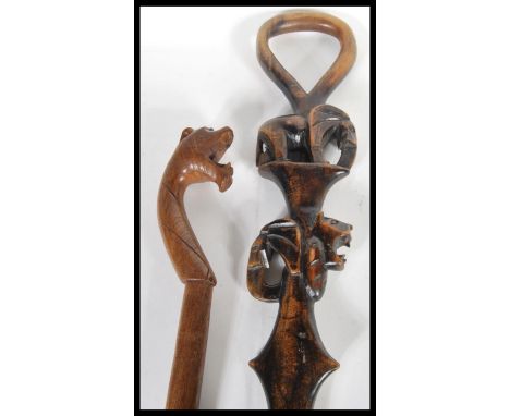 Two vintage walking canes to include a vintage carved African cane carved with Elephant and Tiger decoration. Longest measure