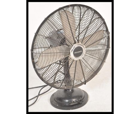 A vintage retro 20th Century industrial desk top fan by Micromark having a wire cage with steel blades. Measures 55 cm high.