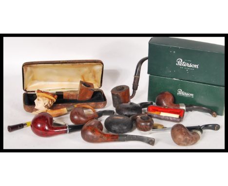 A good collection of vintage smoking tobacco pipes to include two boxed Peterson pipes, cased amber cheroot, Meerschaum, squa