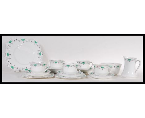 An early 20th Century Art Deco 1930's tea service having a white ground with a green and black pattern, to include tea cups, 