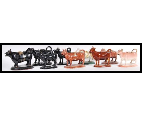 A collection of ceramic creamer jugs modelled as cows to include Staffordshire examples dating from the 19th Century. Nine in