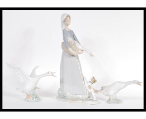 A Lladro ceramic figurine group depicting a girl with goose model 4866 along with two Lladro geese figurines. Impressed and p