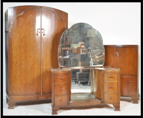 An early 20th Century Art Deco bow front oak bedroom suite consisting of a double wardrobe, tallboy, twin pedestal drop centr