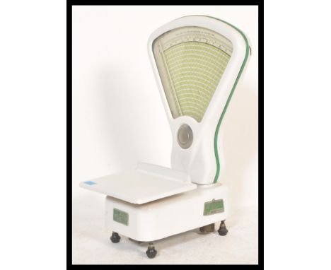 A set of vintage retro 1960's confectioners sweet shop scales by Warmington, having a white enamelled finish and green accent