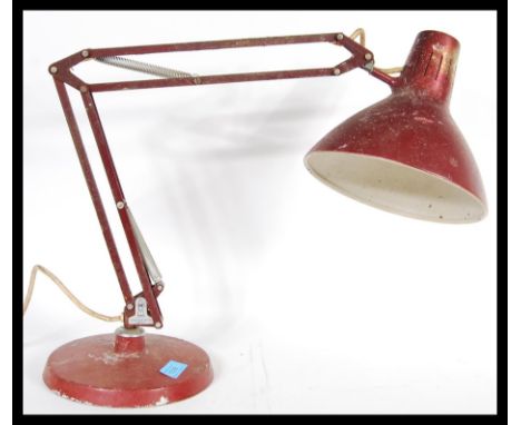 A vintage retro 20th Century 1001 Lamps anglepoise lamp raised on a circular base with conical enamel pendant shade.