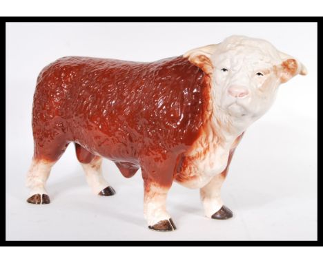 A vintage 20th Century ceramic butchers display figure in the form of a hereford bull, being hand painted in brown and white.
