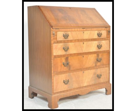 A 20th Century Georgian revival flame mahogany bureau, full front with fully appointed interior over four long graduating dra