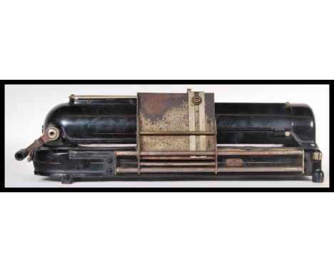 An early 20th Century vintage industrial Protectograph Cheque Writer machine having a black enamel finish. Measures 14cm high
