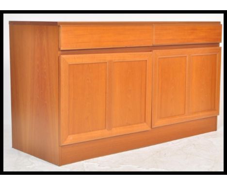 A vintage retro 20th Century Macintosh teak low sideboard credenza unit having two drawers flanked by two cupboards. Measures