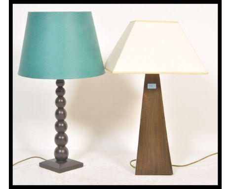 Two vintage retro 20th Century wooden Okra lamps one having a bulbous knopped column and the other of tapering form. Complete