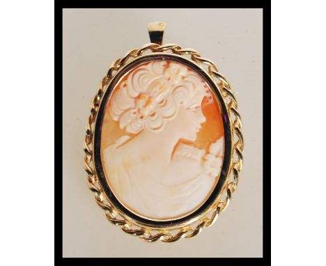 A hallmarked 9ct gold carved shell cameo brooch / pendant having central carved cameo portrait of a maiden facing right in ro