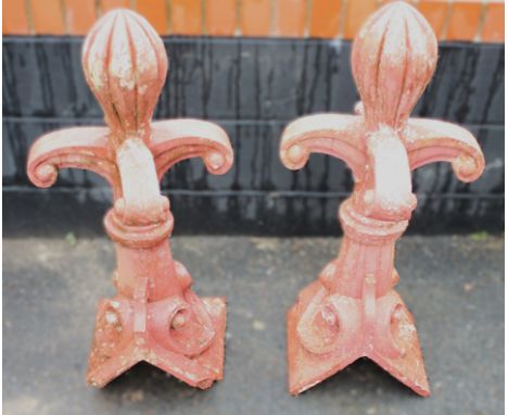 A pair of cast painted stone architectural roof balustrade finials, each with a lobed fruit shaped terminal over four scrolle