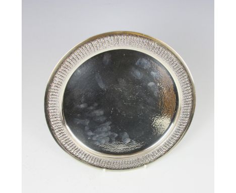 A late 20th century silver salver, Stuart Devlin, London 1973, the openwork organically designed rim above planished well, 25