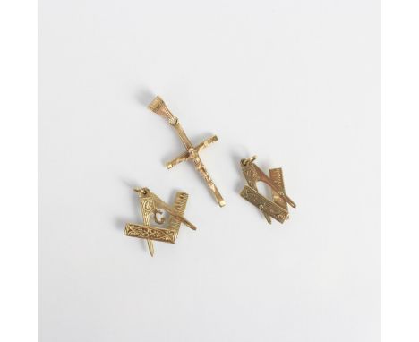A selection of three 9ct charms, including a Crucifix pendant, stamped to reverse, 4.5cm long, with two further 9ct gold stam