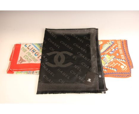 A Chanel shawl, designed as a repeating Chanel logo in silver thread against a black ground, 65% cashmere, 35% silk, 182cm x 