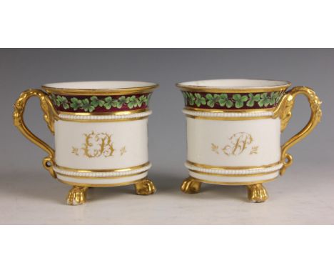 A pair of Worcester porcelain heraldic cabinet cups, early 19h century, retailed by Donovan of Dublin, each circular cup rais