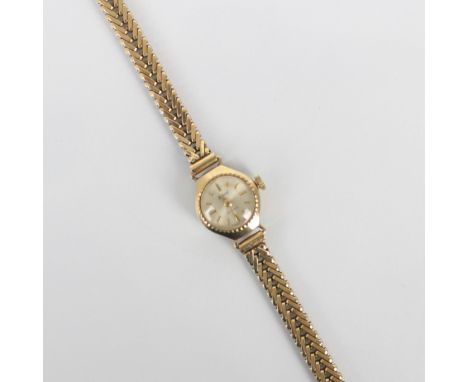 A ladies 9ct gold Accurist wristwatch, the circular dial with baton markers, set to a plain polished case, 1.5cm wide (includ