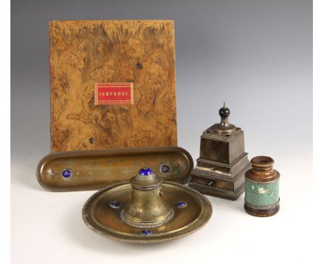 A Victorian brass and enamel inkwell, of circular form with a central covered well, applied with three enamel cabochons and c