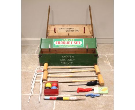 A Jaques croquet set, to include; four branded mallets, six iron hoops, three coloured flag markers, four composition croquet