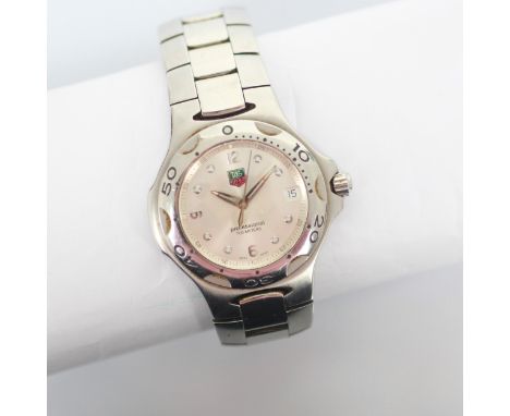 A Tag Heuer professional 200m quartz wristwatch, the circular cream dial with dot markers and date aperture to 3 o'clock, wit