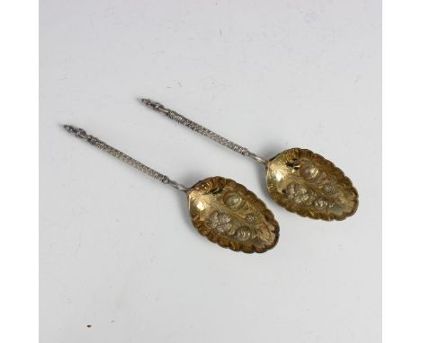 A pair of Victorian silver berry spoons, William Hutton and Sons, London 1883, the cast terminals leading to scale designed s