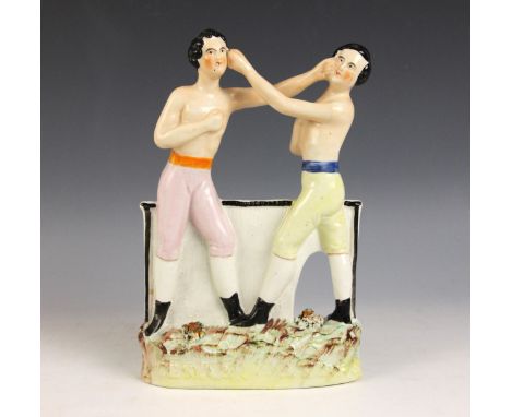 A Staffordshire 'Heenan Sayers' boxing group, mid 19th century, modelled as American boxer Carmel Heenan fighting the English
