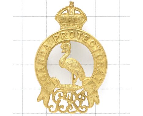 Uganda Protectorate Officer's scarce gilt helmet badge circa 1911-35.Fine die-cast rich gilt crowned ‘UGANDA PROTECTORATE’ ho
