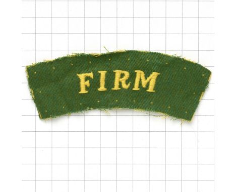 FIRM WW2 cloth shoulder title (11th Bn. Worcesters)A good scarce yellow on green printed example, the ‘FIRM’ over embroidered