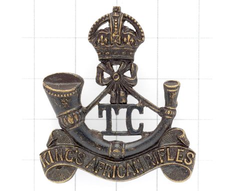 King’s African Rifles scarce Training Company scarce pre 1953 cap badge.Die-cast crowned strung bugle on title scroll, ‘TC’ l