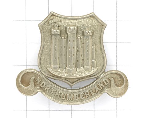 Northumberland Constabulary Victorian police helmet badge.Die-stamped white metal shield with Alnwick Castle resting on ‘NORT