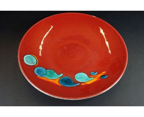 Large Poole Pottery ' Odyssey ' pattern charger, with turquoise blue and orange decoration on a deep red ground, approx 40cm 