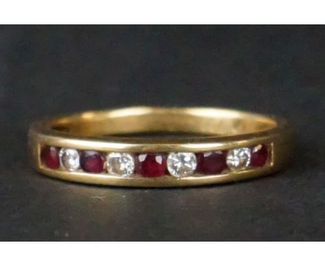 A ladies fully hallmarked 18ct yellow gold half eternity ring. 