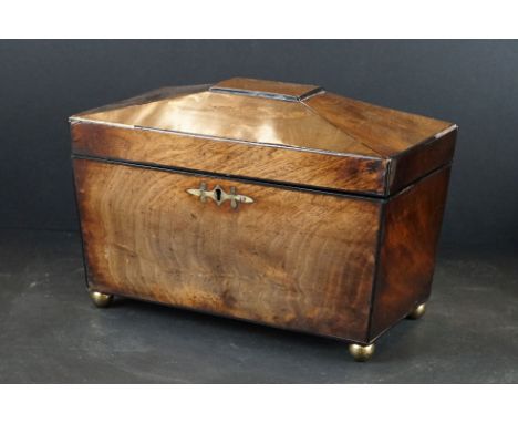 An antique mahogany sarcophagus tea caddy with three internal sections and brass fittings. 