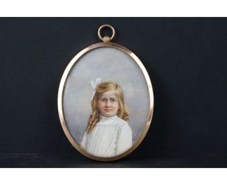 An antique miniature oil portrait of a young girl, indistinctly signed. 