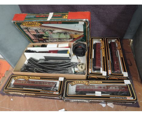 A Mainline 00 gauge Light Goods Set along with a Mainline 00 gauge 0-6-0 J72 Locomotive and four Mainline 00 gauge Carriages,