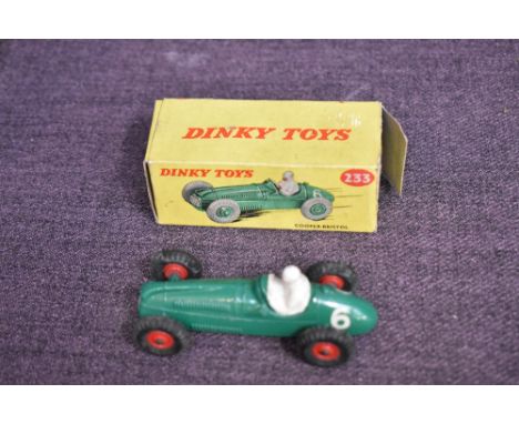 A Dinky diecast, 233 Cooper Bristol in green with racing no 6 and driver present, red hubs, in original box missing one end f