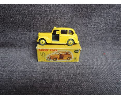 A Dinky diecast, 254 Austin Taxi, Yellow, in original box, missing end flaps
CONDITION REPORT
Original paintwork and overall 