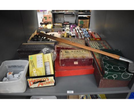 A shelf of vintage Games and Toys including Dometo, Gossima Ping Pong, Table Croquet, Golf Clubs, miniature ceramic tea sets 