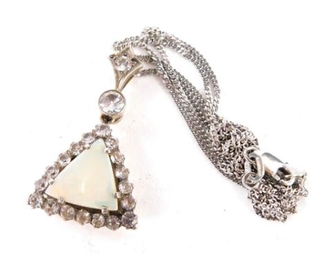 An Art Deco style pendant and chain, the triangle set pendant with a central opal surrounded by white paste stones on a silve