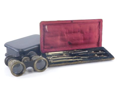 A cased geometry set, an early 20thC box of oblong form and a pair of opera binoculars. (3) 