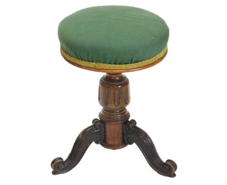 A Victorian rosewood adjustable piano stool, with a green upholstered padded seat, on a turned column and carved tripod base,