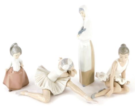 Four Lladro and Nao porcelain figures, to include lady nursing rabbit, 27cm high, female child, 15cm high, a Lladro seated ba