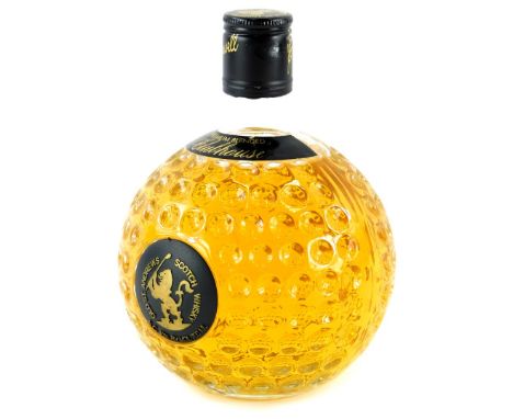 A bottle of Old St Andrews Scotch Whisky Premium blended Clubhouse, in golf ball shaped bottle.