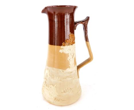 A Royal Doulton stoneware jug, the top with brown treacle glazed decoration and applied leaf moulded decoration of a hunting 