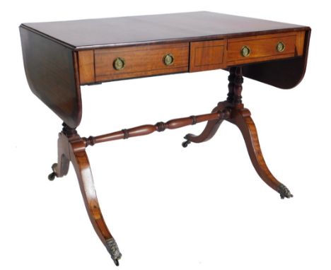 A 19thC satinwood and mahogany sofa table, with ebony stringing, the rectangular top with rounded ends, above two frieze draw