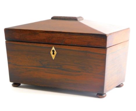 A 19thC rosewood sarcophagus shaped tea caddy, the hinged lid enclosing two lidded compartments, with an ivory escutcheon and