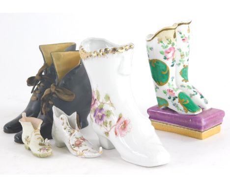 A pair of 19thC continental ceramic laced boots, a Paris porcelain pair of boots, (AF), and another similar item. (6)